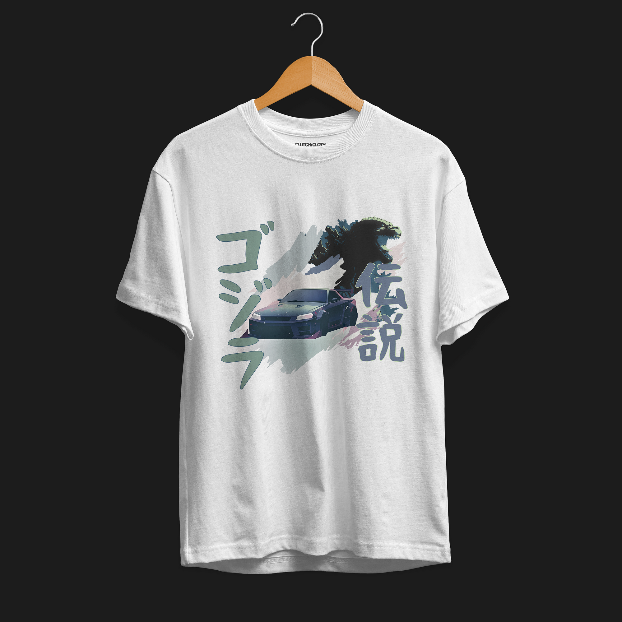 Front of White R34 Godzilla Legend Automotive Graphic T-Shirt featuring a Nissan Skyline GT-R with a Godzilla figure and Japanese text, unisex car enthusiast gift