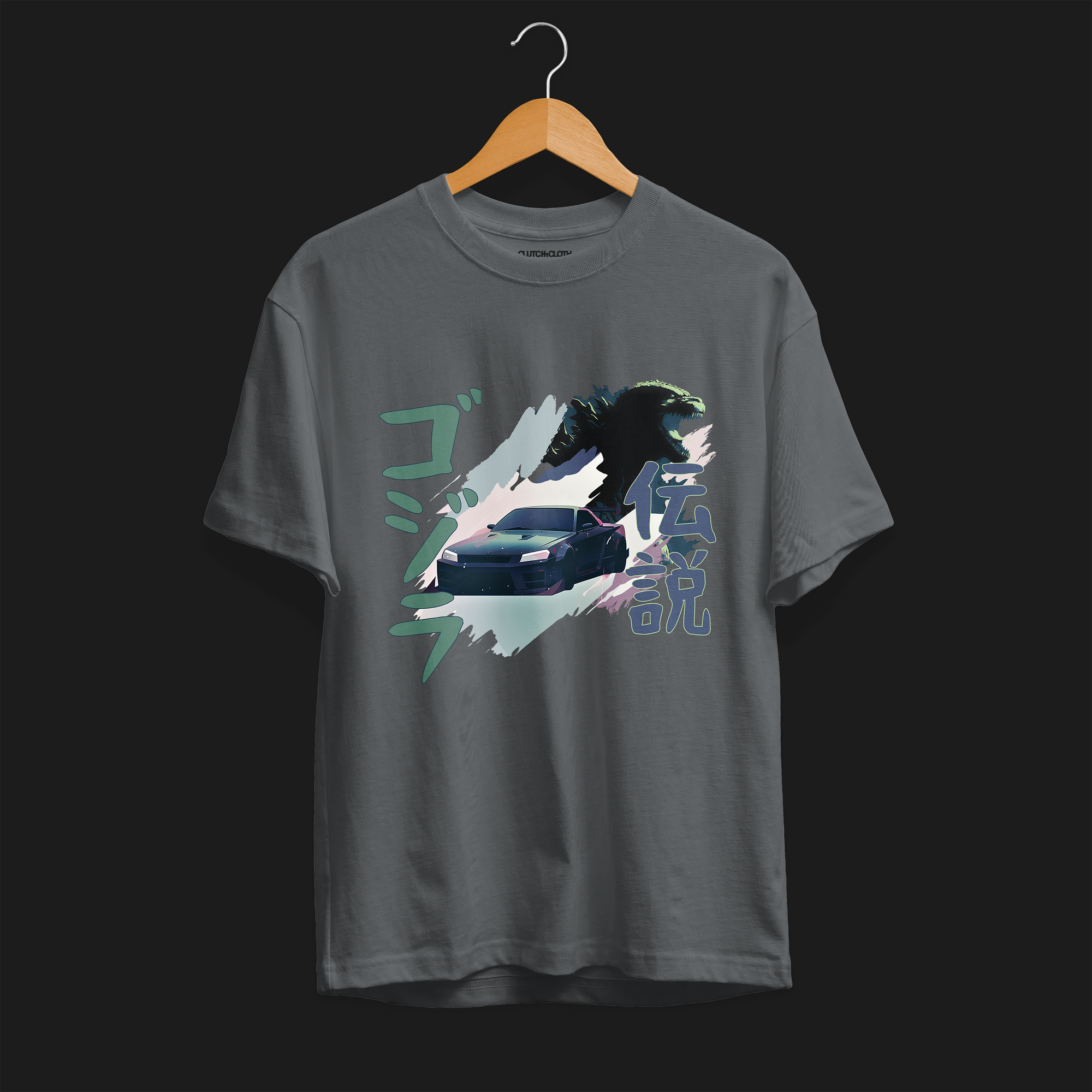 Front of Charcoal R34 Godzilla Legend Automotive Graphic T-Shirt featuring a Nissan Skyline GT-R with a Godzilla figure and Japanese text, unisex car enthusiast gift
