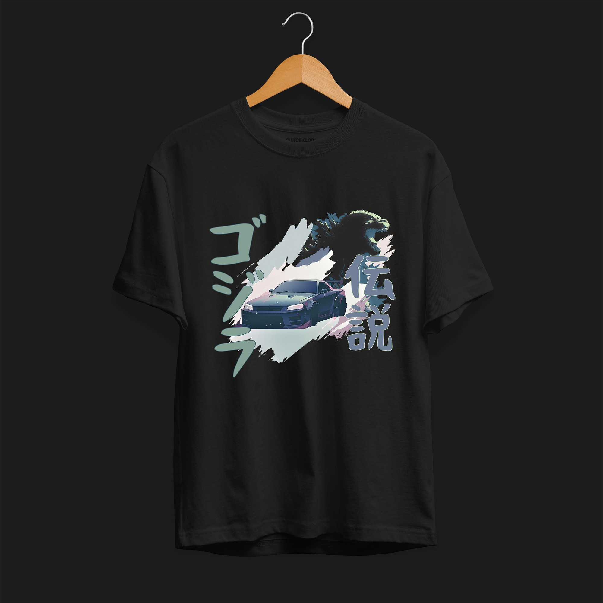 Front of Black R34 Godzilla Legend Automotive Graphic T-Shirt featuring a Nissan Skyline GT-R with a Godzilla figure and Japanese text, unisex car enthusiast gift