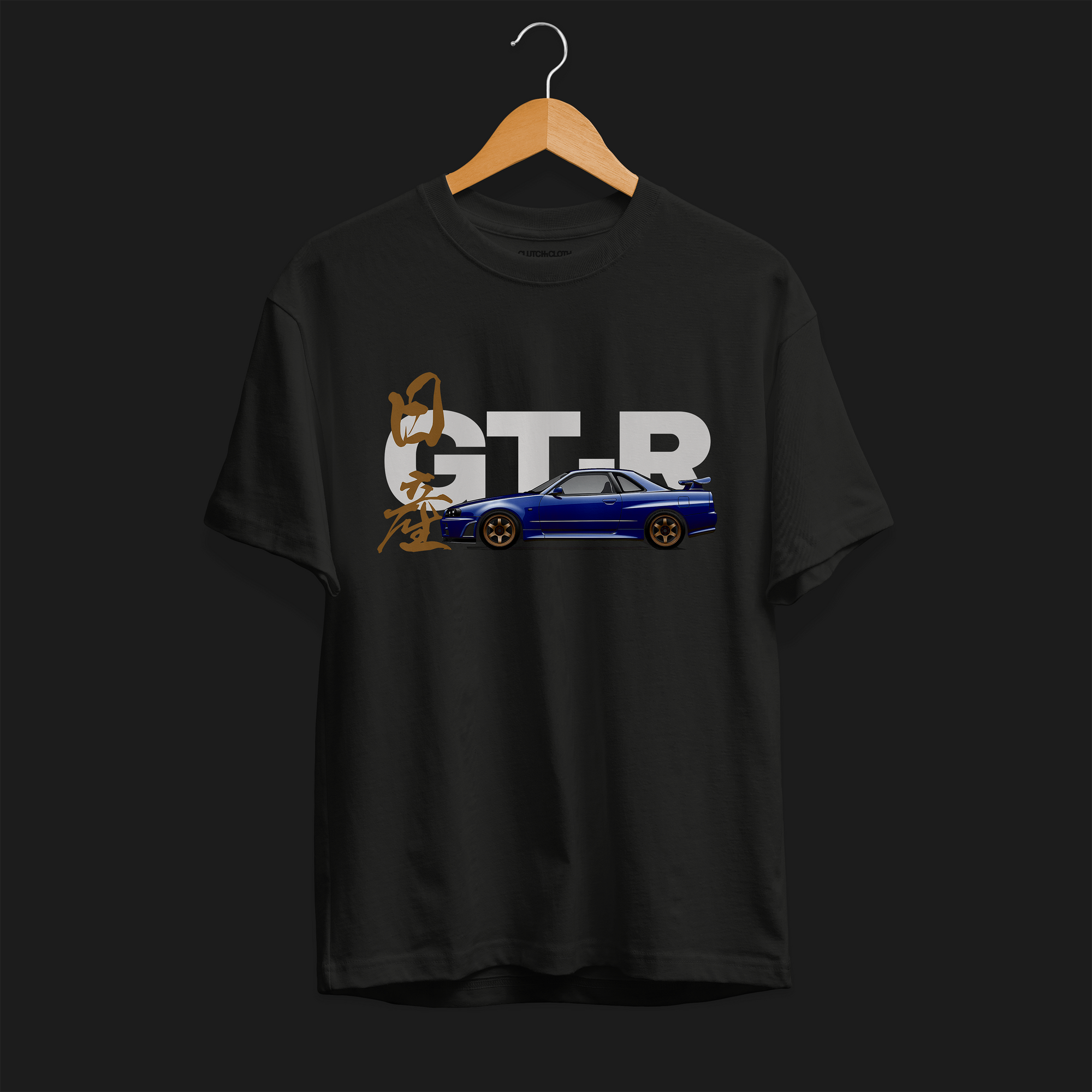 Front of Black R34 GT-R Automotive Graphic T-Shirt featuring a blue Nissan Skyline with gold accents and Japanese calligraphy design, unisex car enthusiast gift.