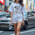 Woman wearing Legendary Suzuka RX7 Automotive Graphic T-Shirt – Blue tee featuring detailed RX7 graphics with Japanese lettering and racing elements. Perfect gift for JDM and car culture enthusiasts.