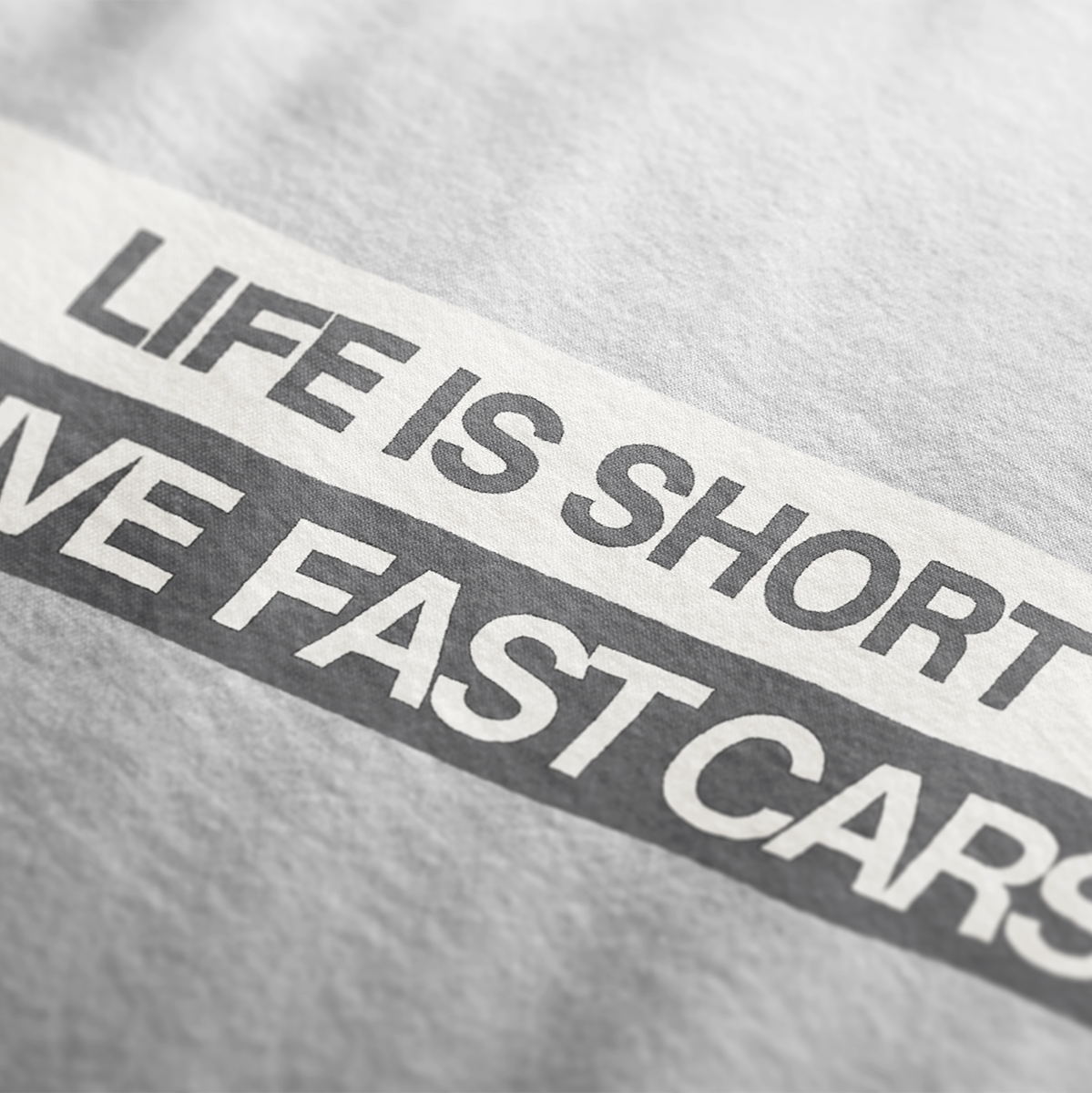 Close up of Life is Short, Drive Fast Cars Automotive Graphic T-Shirt Design – White unisex tee featuring a minimalist text design. A perfect gift for car lovers and speed enthusiasts.