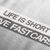 Close up of Life is Short, Drive Fast Cars Automotive Graphic T-Shirt Design – White unisex tee featuring a minimalist text design. A perfect gift for car lovers and speed enthusiasts.