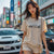 woman wearing P1 GTR Automotive Graphic T-Shirt – Beige unisex tee featuring a minimalist line art illustration of the P1 GTR supercar. A perfect gift for car enthusiasts and motorsport fans.