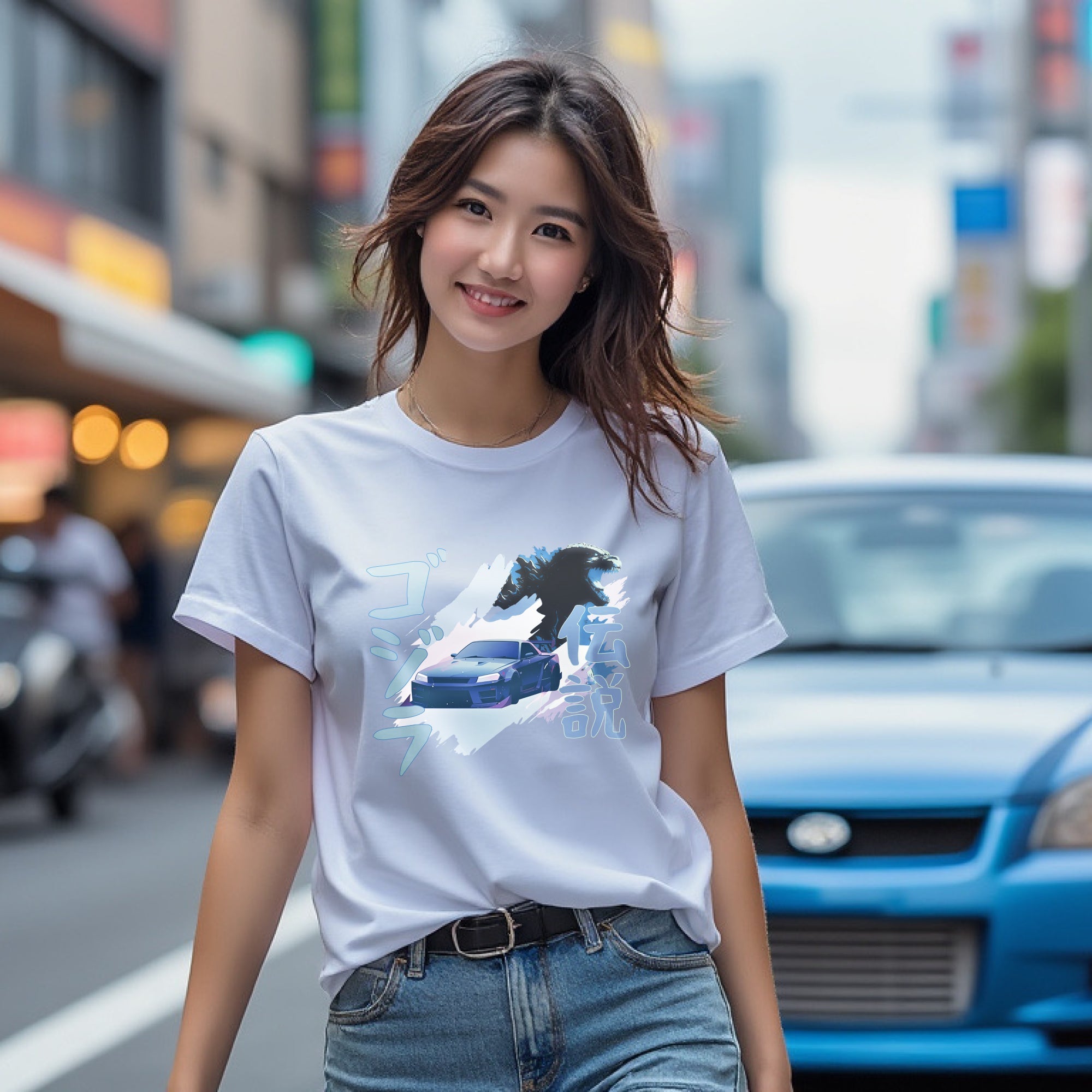 Woman wearing white R34 Godzilla Legend Automotive Graphic T-Shirt featuring a Nissan Skyline GT-R with a Godzilla figure and Japanese text, unisex car enthusiast gift
