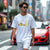 Man wearing white RX-7 Rotary Legend Automotive Graphic T-Shirt featuring a yellow Mazda RX-7 with Japanese text and RX-7 lettering, unisex car enthusiast gift