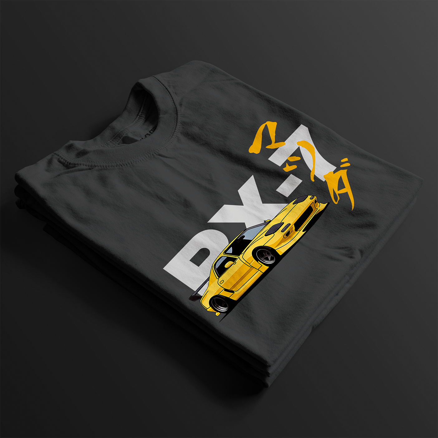 Folded Black RX-7 Rotary Legend Automotive Graphic T-Shirt featuring a yellow Mazda RX-7 with Japanese text and RX-7 lettering, unisex car enthusiast gift