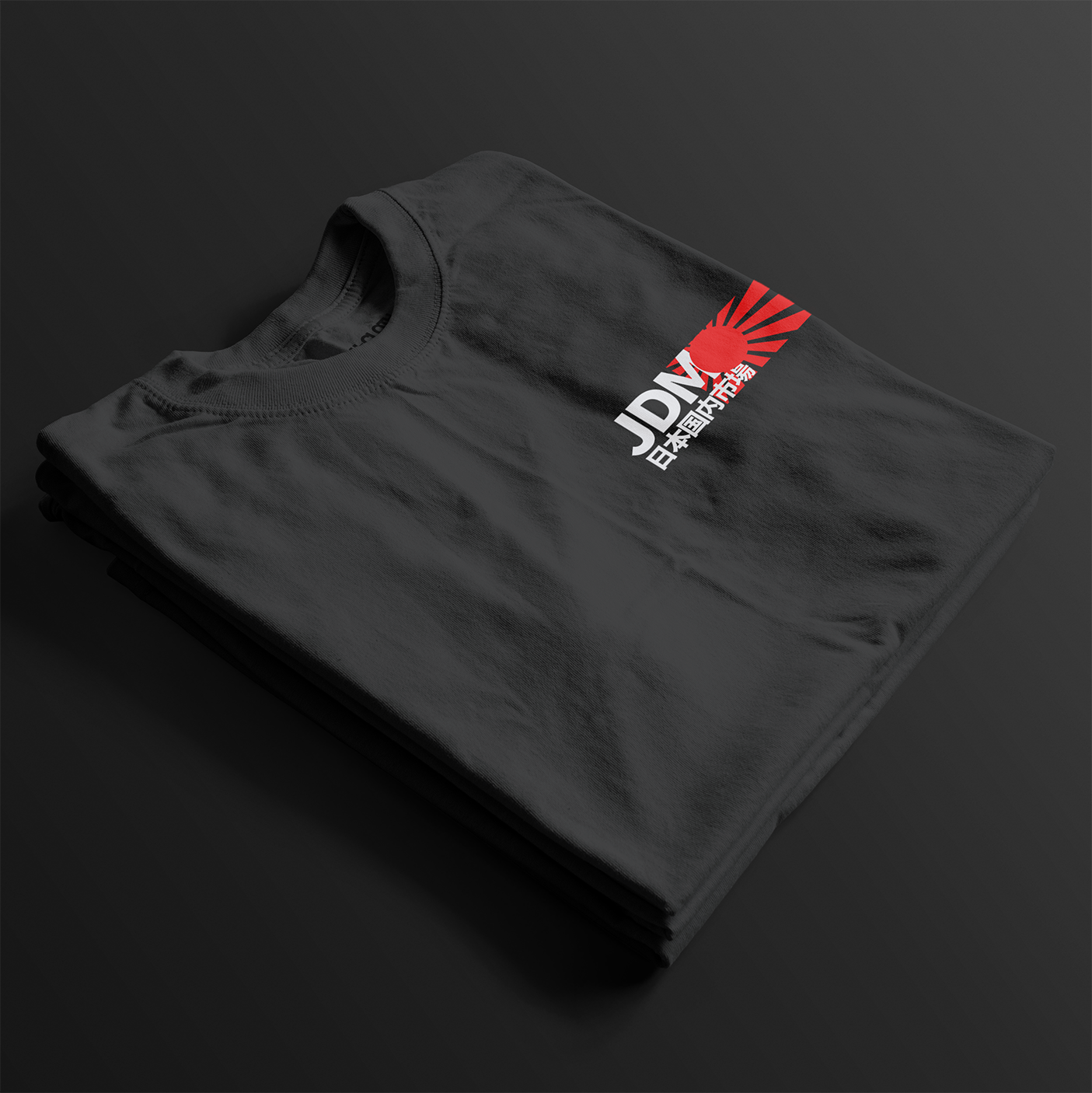 Folded Black JDM Rising Sun Automotive Graphic T-Shirt with JDM text and a red rising sun graphic, unisex car culture gift