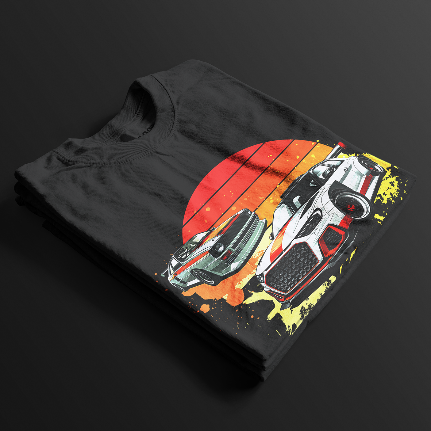 Folded Racing Sport Rally Sunset Automotive Graphic T-Shirt – Black unisex tee featuring a rally car and a vintage car against a bold sunset background in shades of red, orange, and yellow. Ideal gift for car and motorsport enthusiasts.