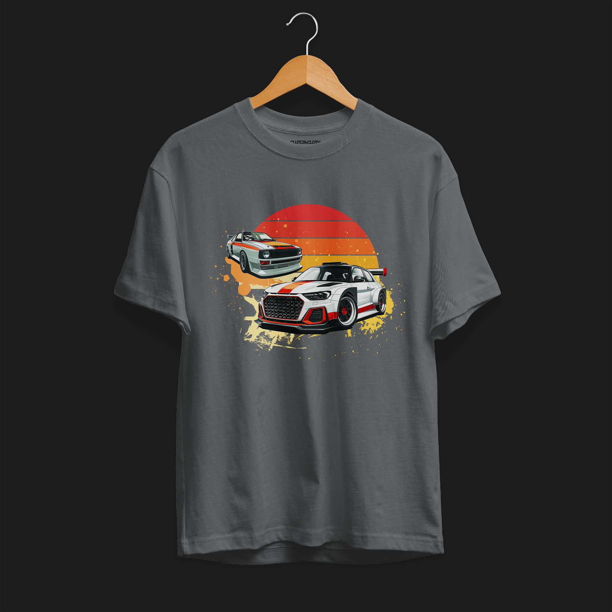 Front of Racing Sport Rally Sunset Automotive Graphic T-Shirt – Charcoal unisex tee featuring a rally car and a vintage car against a bold sunset background in shades of red, orange, and yellow. Ideal gift for car and motorsport enthusiasts.