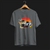 Front of Racing Sport Rally Sunset Automotive Graphic T-Shirt – Charcoal unisex tee featuring a rally car and a vintage car against a bold sunset background in shades of red, orange, and yellow. Ideal gift for car and motorsport enthusiasts.