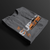 Folded FF Supra Buster Automotive Graphic T-Shirt – Charcoal unisex tee featuring an orange Toyota Supra with Japanese text and a grey 'SUPRA' background. Ideal gift for JDM fans and car enthusiasts.