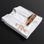 Folded FF Supra Buster Automotive Graphic T-Shirt – White unisex tee featuring an orange Toyota Supra with Japanese text and a grey 'SUPRA' background. Ideal gift for JDM fans and car enthusiasts.