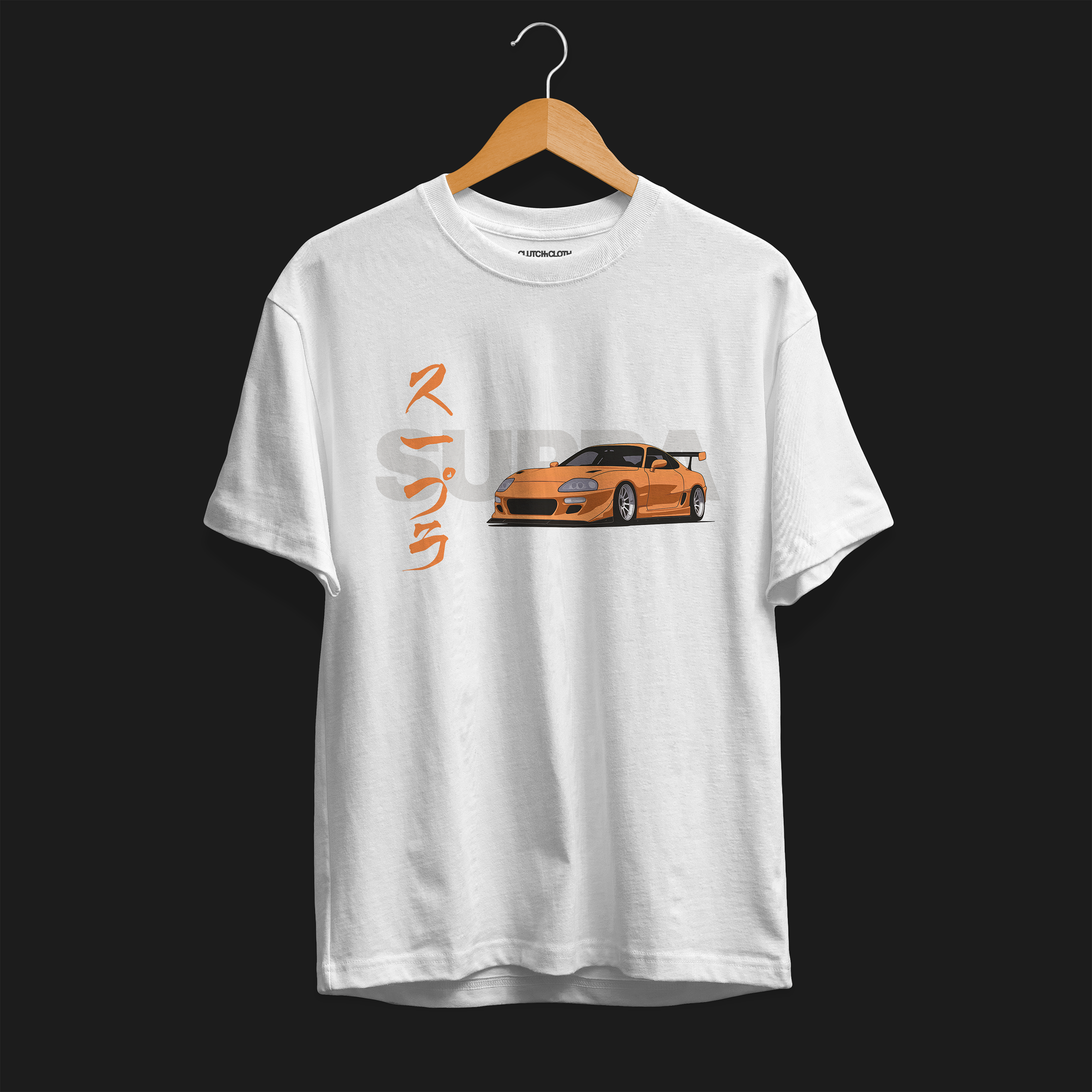 Front of FF Supra Buster Automotive Graphic T-Shirt – White unisex tee featuring an orange Toyota Supra with Japanese text and a grey 'SUPRA' background. Ideal gift for JDM fans and car enthusiasts.