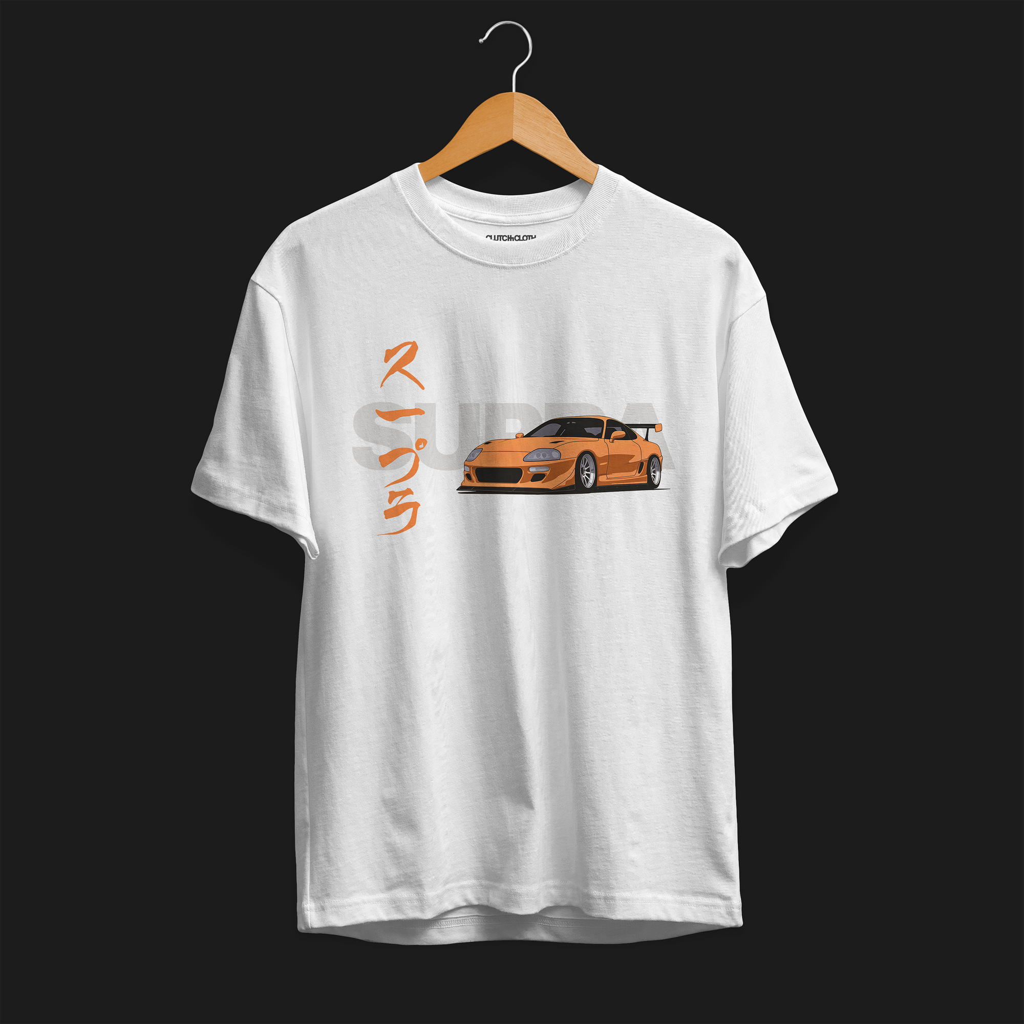Front of FF Supra Buster Automotive Graphic T-Shirt – White unisex tee featuring an orange Toyota Supra with Japanese text and a grey 'SUPRA' background. Ideal gift for JDM fans and car enthusiasts.